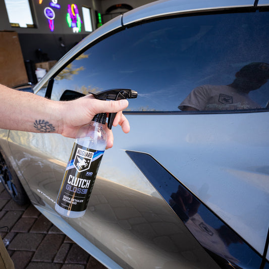 Man spraying quick detailer on driver side car door