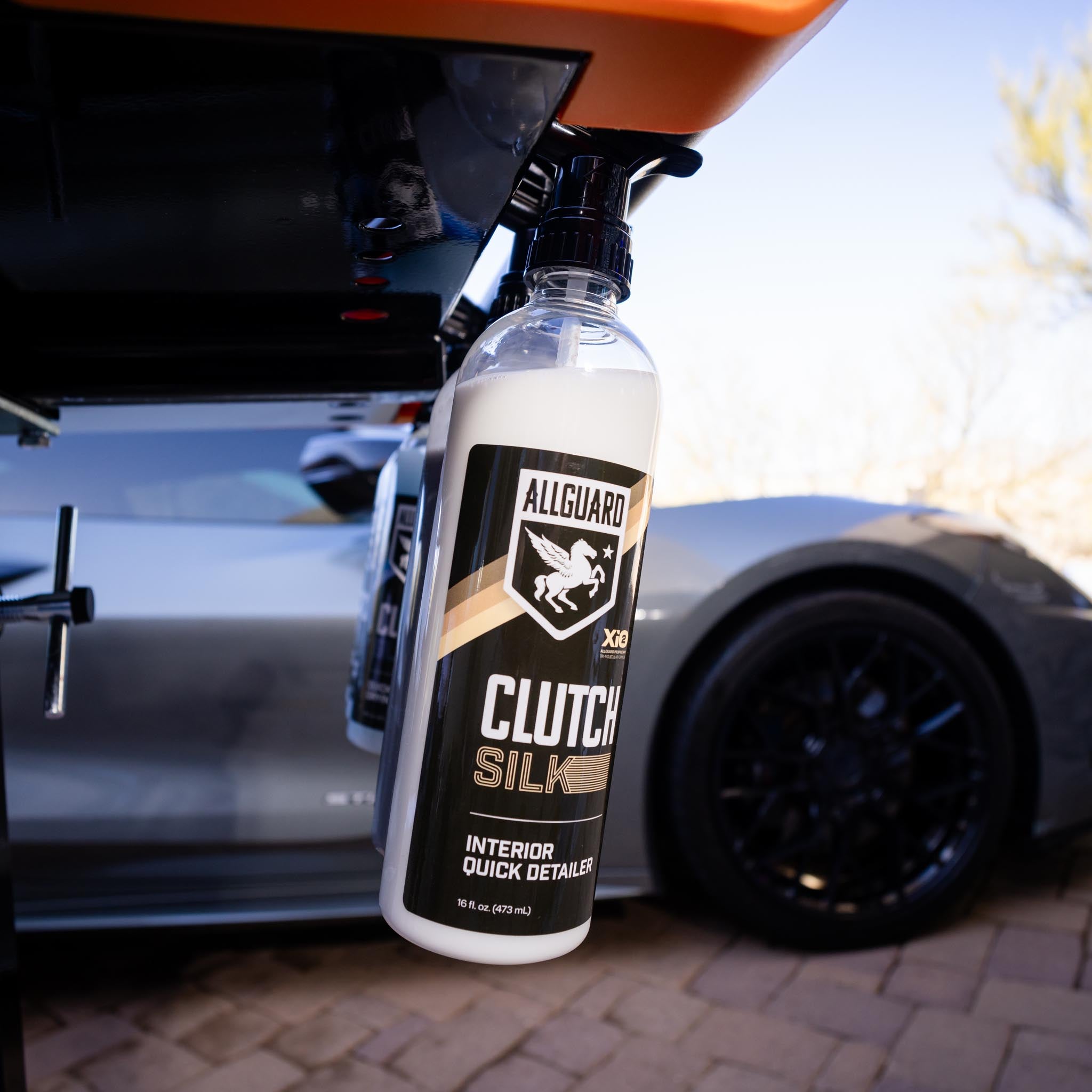 Clutch SILK detailer hanging from work station in front of car during exterior detailing