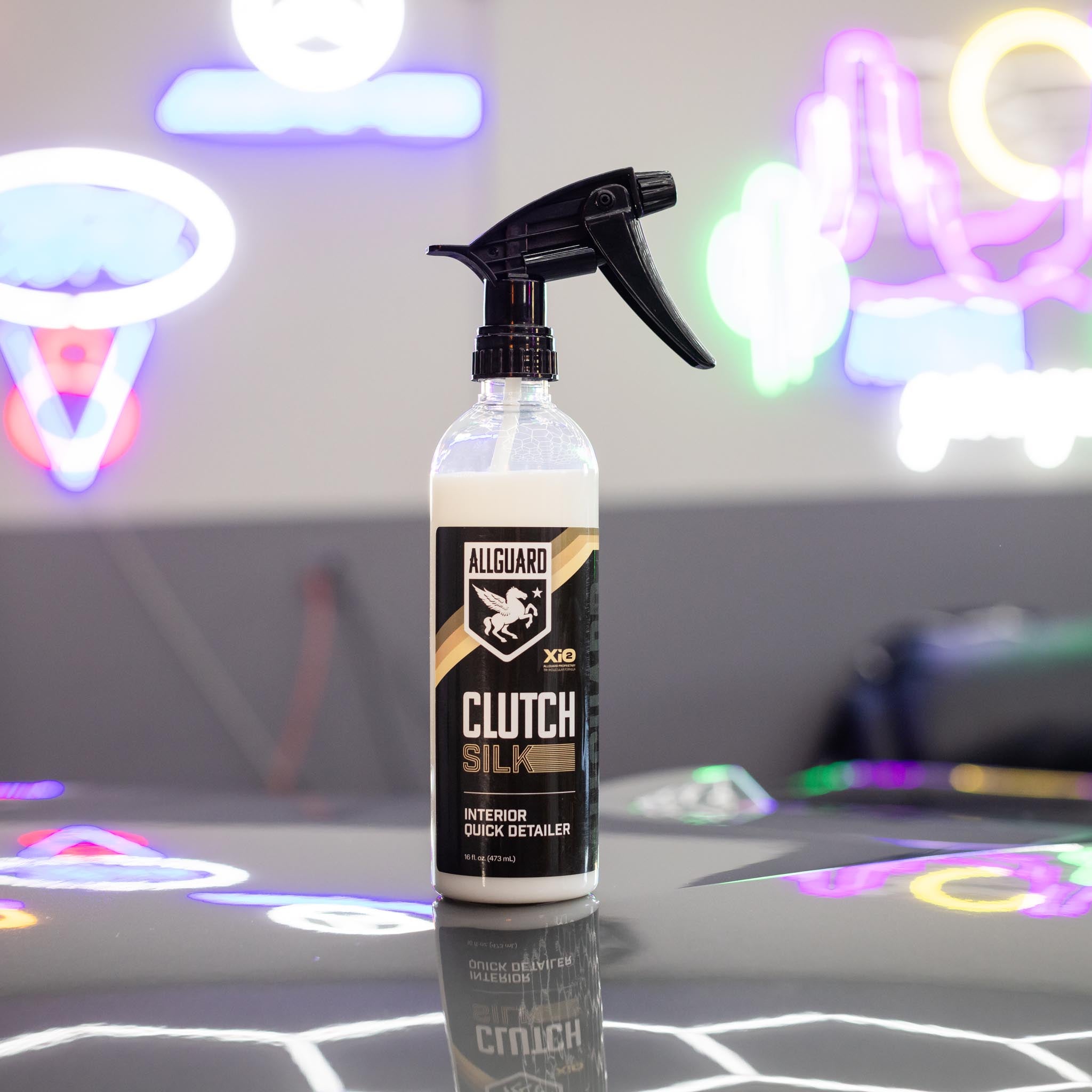 Clutch SILK interior detailer inside garage with hip pink lights in background
