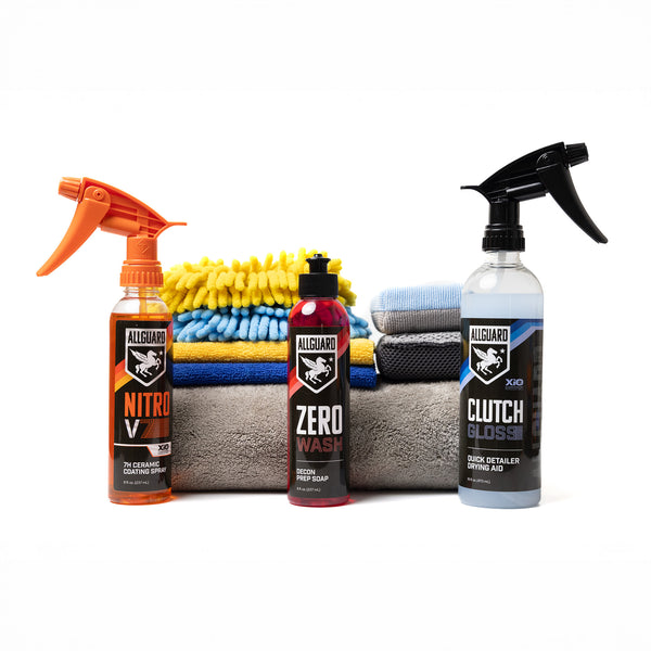 Two detailing sprays and car shampoo soap in front of towels